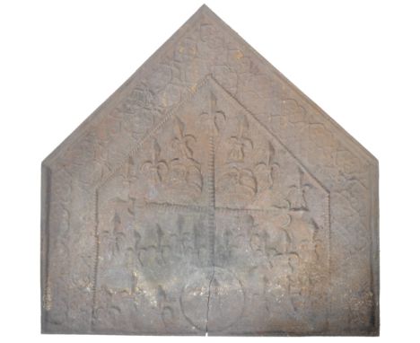 An 18th Century cast iron fireback / fire back of architectural form having a pointed top with relief detailed borers and cen