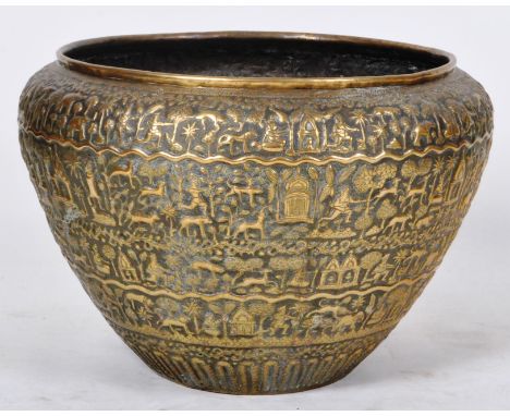 A large 19th Century Indian Colonial period Mughal brass jardiniere planter having intricate repousse decoration depicting an