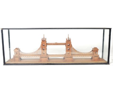 A large 19th Century Victorian cased model of Tower Bridge. Constructed from many pieces of fret worked teak / oak and housed