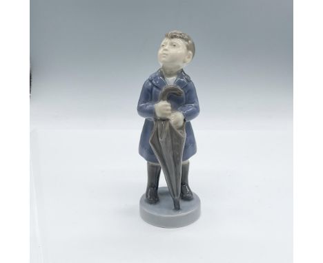 Glossy porcelain figurine of a young boy holding his closed umbrella after the rain. Royal Copenhagen backstamp. #4526. Issue