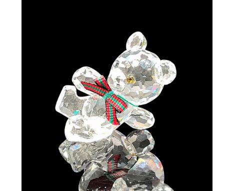 Clear crystal leaning figural with amber, black eyes wearing a holiday bow tie. Swarovski backstamp. 7637 000 001. This item 