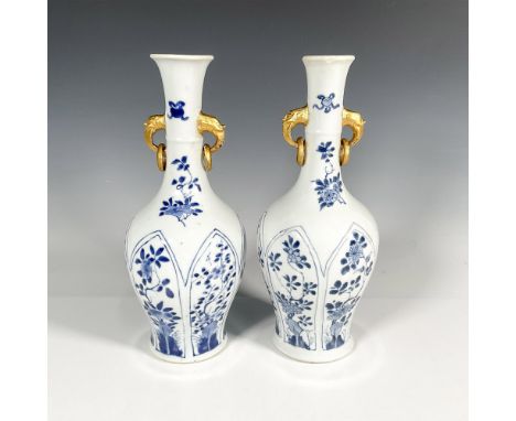 Two beautiful white ground baluster vases decorated in hand painted blue flowers and double gilded handles. Kangxi period lea