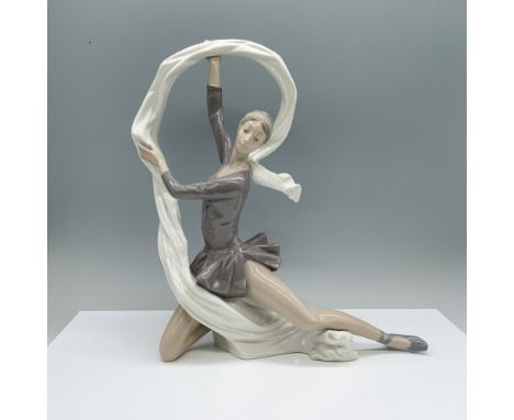 A graceful figurine of a woman poised in a crouched ballet position, delicately holding a flowing veil around her. Nao by Lla