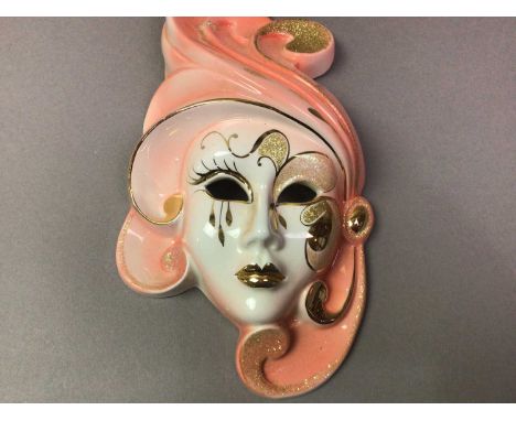 GRADUATED SET OF THREE MID-CENTURY WALL MASKS ALONG WITH A CIELING PENDANT all ceramic, the pendant with floral decoration 