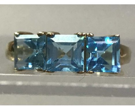 NINE CARAT GOLD DRESS RING  set with three topaz stonesThe ring is a size P, the colour of the stones is a baby blue. Minor s