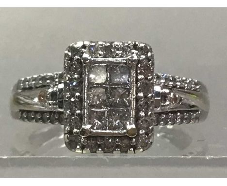 NINE CARAT WHITE GOLD RING set with diamonds