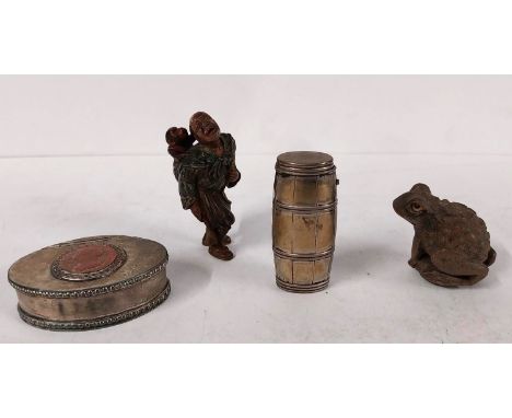 Two Japanese carved wood netsukes, one of a toad and one of a man with hair being pulled by a monkey along with a barrel form