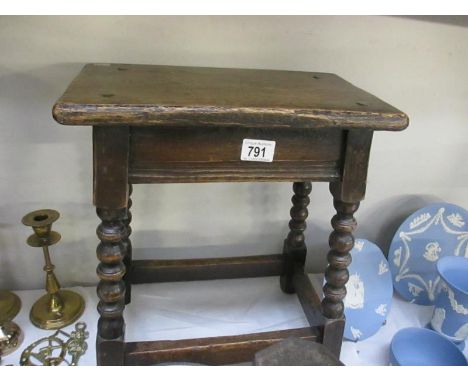 An old wooden stool with barley twist legs