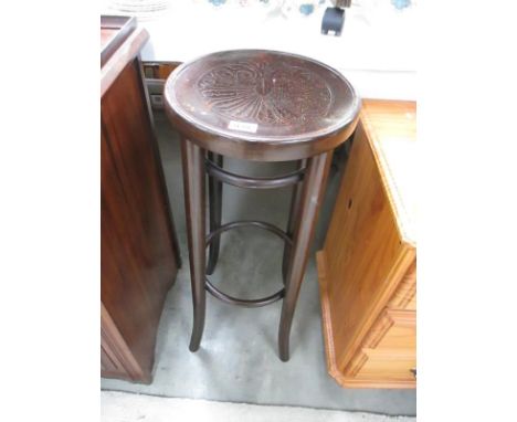 A tall dark wood stool