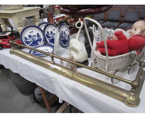 A vintage brass fire fender