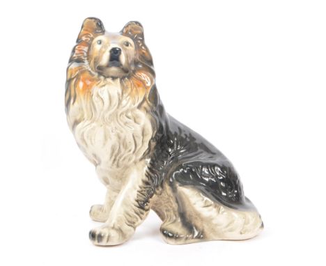 A vintage mid 20th century circa 1960s ceramic pottery figure of a dog. Rough collie breed, in a seated position with tones o