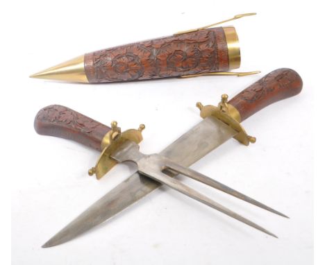 A vintage Indian fish knife and fork set housed in a hand carved double scabbard with brass latch and mounts. Measures approx