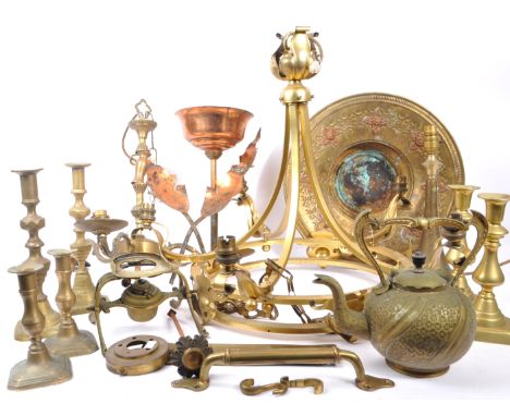 A collection of brass and copper items to include a decorative spirit kettle on stand, six candlesticks, brass three arm chan