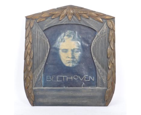 A late 19th Century arts and crafts Liberty style hand carved wooden picture frame decorated with foliate / leaf design to bo