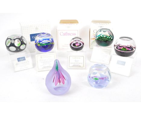 Caithness - A collection of six Scottish crystal glass handmade paperweights together with a John Deacons glass fuchsia paper