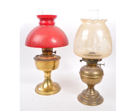 Two vintage 20th century brass table oil lamps. Having glass flutes, with circular shades on brass supports. Measures approx.