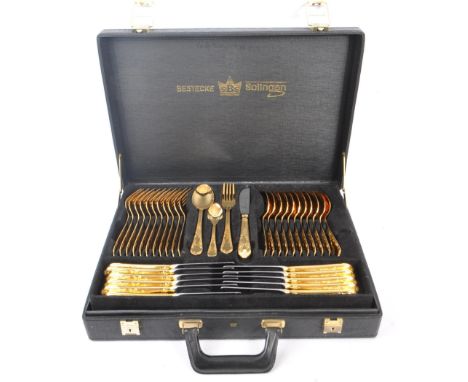 A 20th Century German Bestecke SBS Solingen gold plated 12 person canteen of cutlery to include table forks, table knives, ta