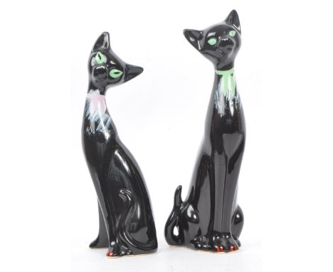 A pair of contemporary ceramic / pottery cat figures / statues. Both in a seated position with hand painted eyes, collars and