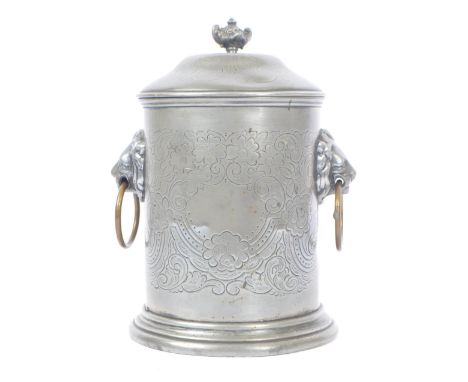 An Anglo-Indian plated circular pewter lidded tea caddy with engraved flourishes and floral pattern, and lions head ring hand