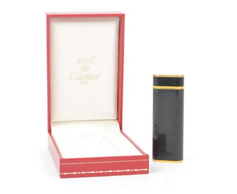 A 20th Century French vintage Must de Cartier Paris 'Trinity' black lacquer and gold plated lighter held within original box.
