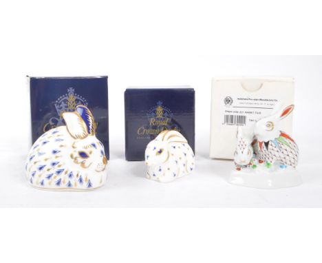 Royal Crown Derby - Two porcelain china rabbit paperweight figures. With stoppers and original boxes. Together with Hollohaza