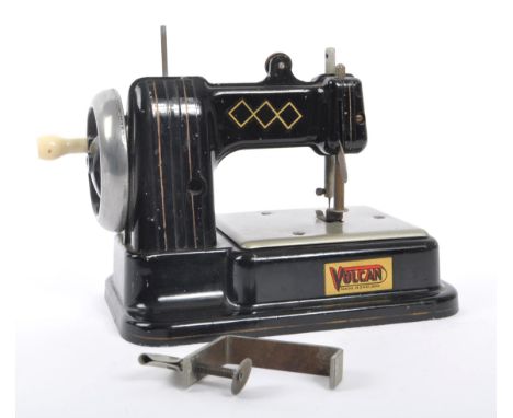 Volcan - Mid 20th century toy tin sewing machine. Made in England with label to side. Black colour way with silver manual whe