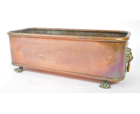A 19th century Victorian copper planter. The planter of rectangular form, raised on cast paw feet, with lions head ring handl