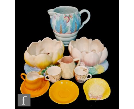 Two Clarice Cliff Lily pad table centre bowls moulded and enamelled as a large flowering water lily, together with a leaf and