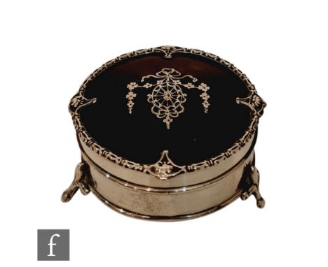 A hallmarked silver and tortoise shell circular trinket box with inlaid silver swag detail to hinged lid, all raised on three