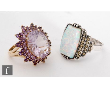 A 9ct amethyst and synthetic amethyst cluster ring,  weight 8.2g, with a synthetic opal and marcasite example. (2) 