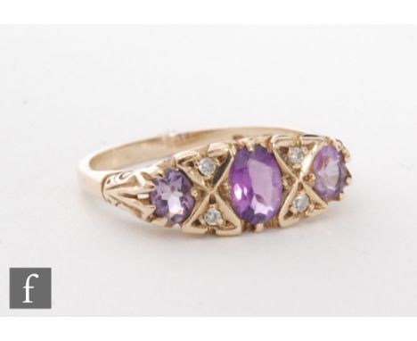 A 9ct hallmarked amethyst and diamond seven stone ring, three amethysts spaced by two pairs of diamonds, weight 2.5g, ring si