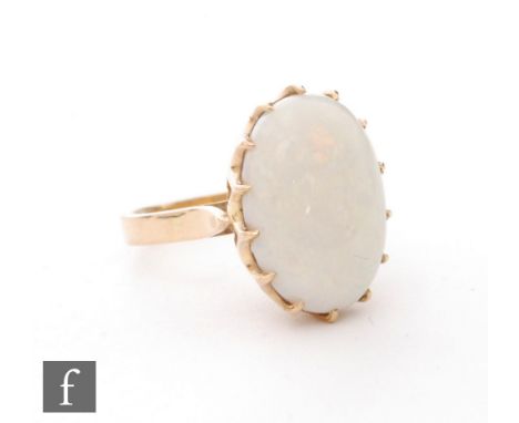 A 9ct opal single stone ring, oval claw set stone to plain shoulders, length of stone 18mm, weight 6g, ring size O. 