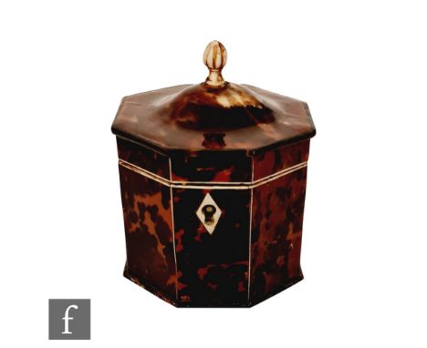 A 19th Century hexagonal tortoiseshell tea caddy terminating in domed hinged cover below bone finial, all raised on four conf