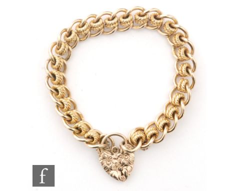 A 9ct hallmarked curb and roller link bracelet terminating in foliate decorated padlock fastener, Birmingham 1978. 