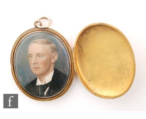 An early 20th Century 9ct rose gold oval locket of plain form opening to a head and shoulder portrait miniature of a gentlema