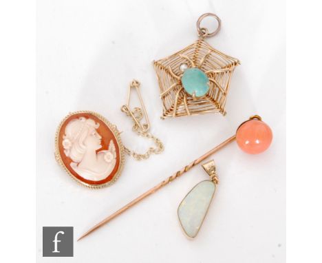 A 9ct mounted cameo brooch, a coral stick pin, an irregular opal pendant and a 9ct pendant of a spider's web. (4) 