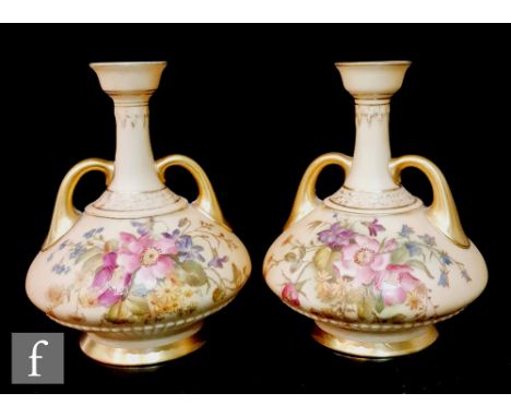 A pair of Royal Worcester shape 1747 twin handled vases each decorated with floral sprays against a blush ivory ground, puce 