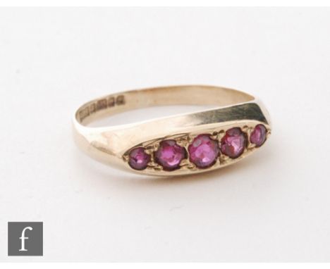 A 9ct hallmarked ruby five stone boat shaped ring of plain form, weight 2.3g, ring size L. 