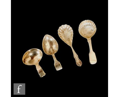 A Georgian hallmarked silver caddy spoon of plain form with a heart shaped example, two Victorian examples each with shell bo