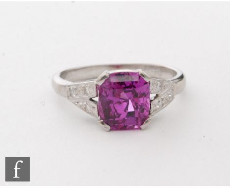 An Art Deco platinum pink sapphire and diamond ring, central claw set cushioned cut sapphire, length 8mm, to diamond set spli