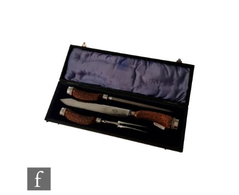 An early 20th Century carving set, the horn handles with Sheffield steel fittings, R. F. Moseley Ltd. set within a fitted cas