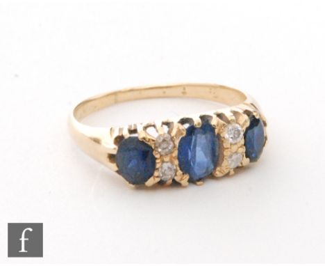 An early 20th Century 18ct sapphire and diamond seven stone, boat shaped ring, three sapphires spaced by two pairs of diamond