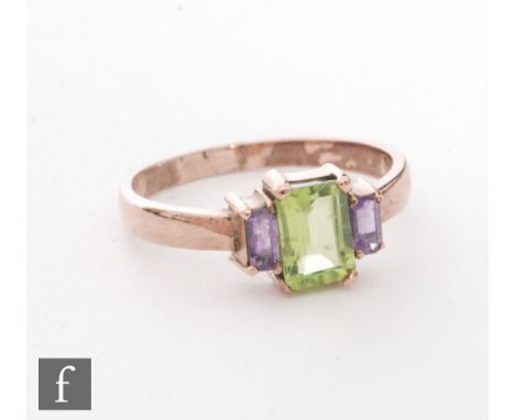 A modern 9ct rose gold amethyst and peridot and amethyst three stone ring, central peridot flanked by amethyst, weight 2.4g, 