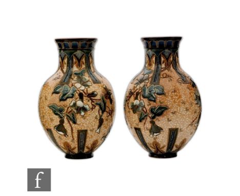 A pair of late 19th Century Doulton Lambeth vases each decorated by Edith Lupton with carved bell flowers and foliage heighte