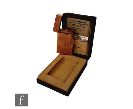 A cased Dupont gold plated lighter with diamond cut decoration to whole with guarantee, instruction booklet and flints. 
