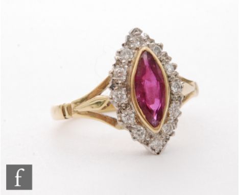 An 18ct hallmarked ruby and diamond cluster ring, central marquise cut, collar set ruby within a twelve stone diamond surroun