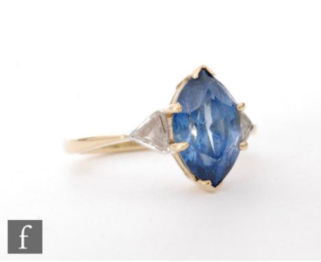 An 18ct sapphire and diamond three stone ring, central marquise cut sapphire, length 10.5mm, flanked by a triangular cut diam