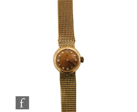 A lady's 18ct hallmarked Omega automatic wrist watch, diamond set and plain batons to a circular champagne dial, case diamete