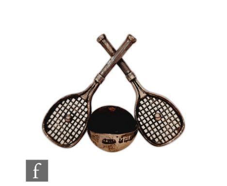 A silver hallmarked pin cushion modelled as crossed tennis rackets with central cushion, Birmingham 1908, Adie &amp; Lovekin 