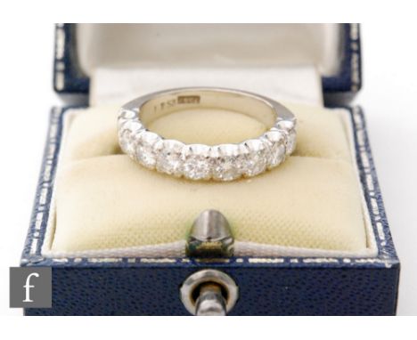 A mid 20th Century 18ct white gold diamond half eternity ring, comprising nine claw set brilliant cut stones, total weight ap